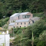 Thumbnail of http://The%20modern%20extension%20sits%20on%20the%20slope%20above%20the%20traditional%20cottages