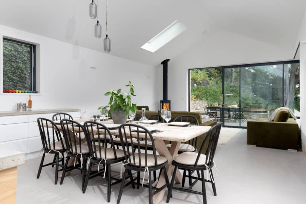 The large open plan family space is filled full of light by the large windows and doors