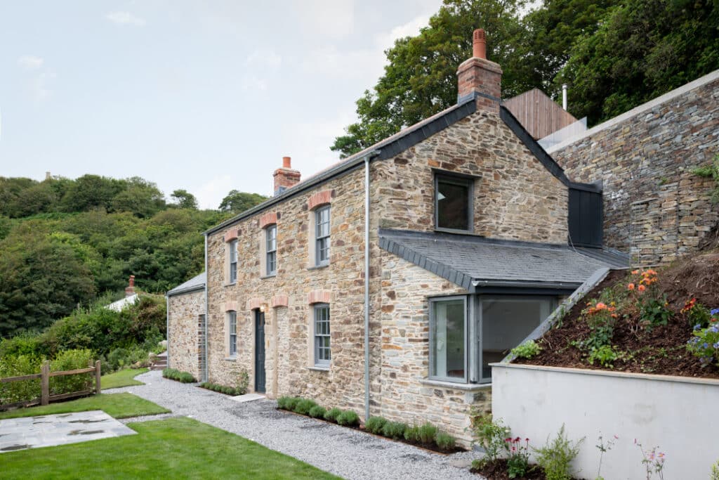 The two stone miners cottages have been combined into one building to create the bedroom wing of the new property