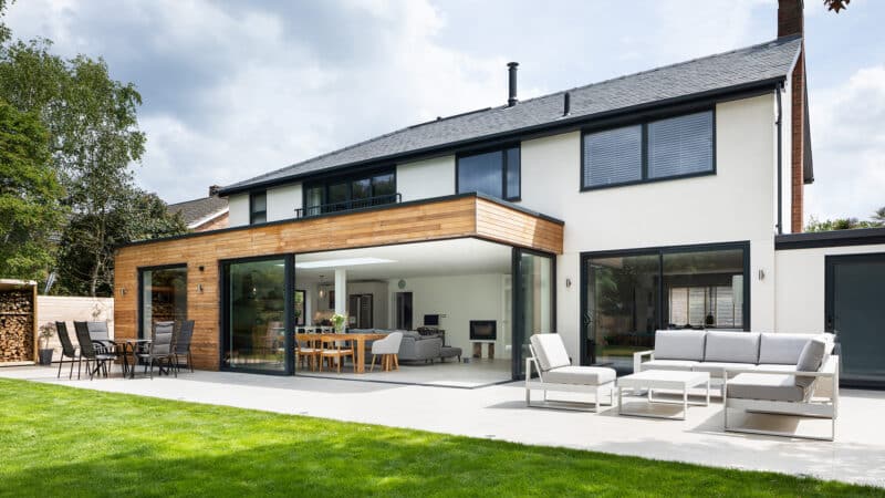 Modern house extension with Sunflex SVG30 open corner doors creating seamless indoor-outdoor living space.